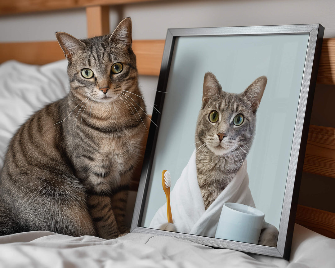 Custom cat bathroom picture of a tabby cat wearing a white bathrobe and holding a toothbrush next to the real cat on a bed.