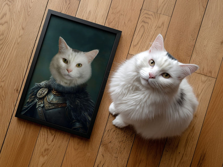 Royal pet portrait in a black frame featuring a white cat as a noble knight sitting on a wooden floor next to the cat.